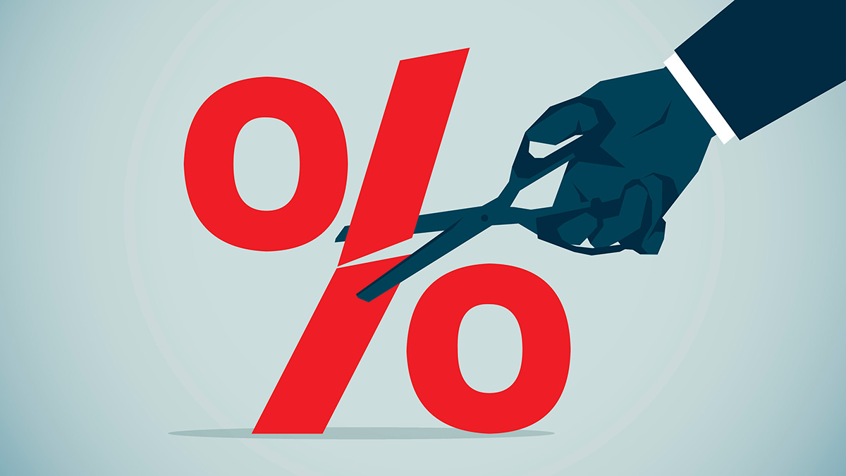 Hand holding scissors cutting interest rate percentage