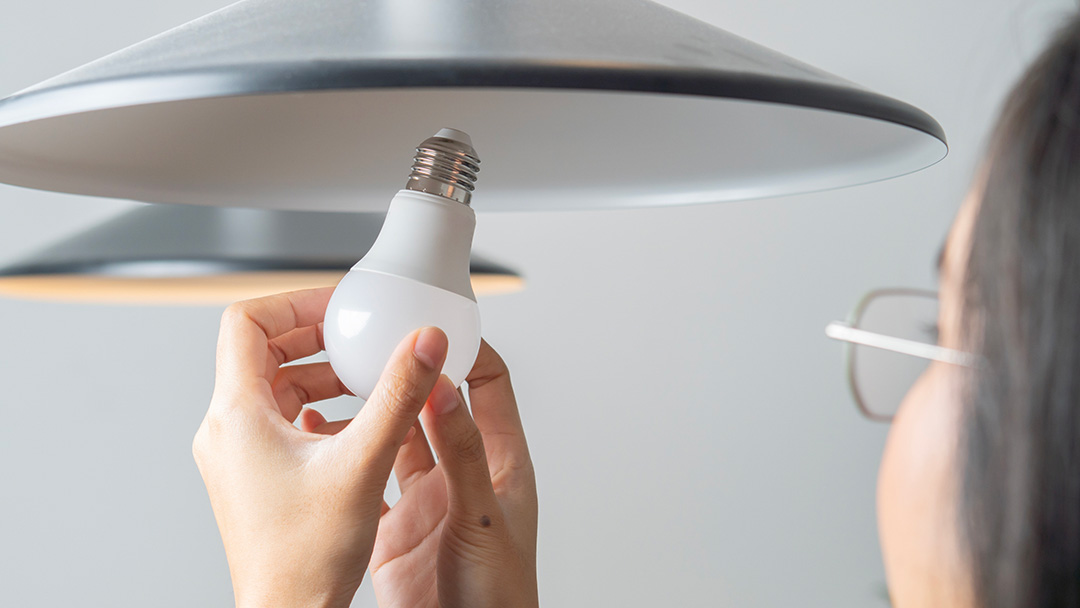 Person fitting an energy-efficient lightbulb